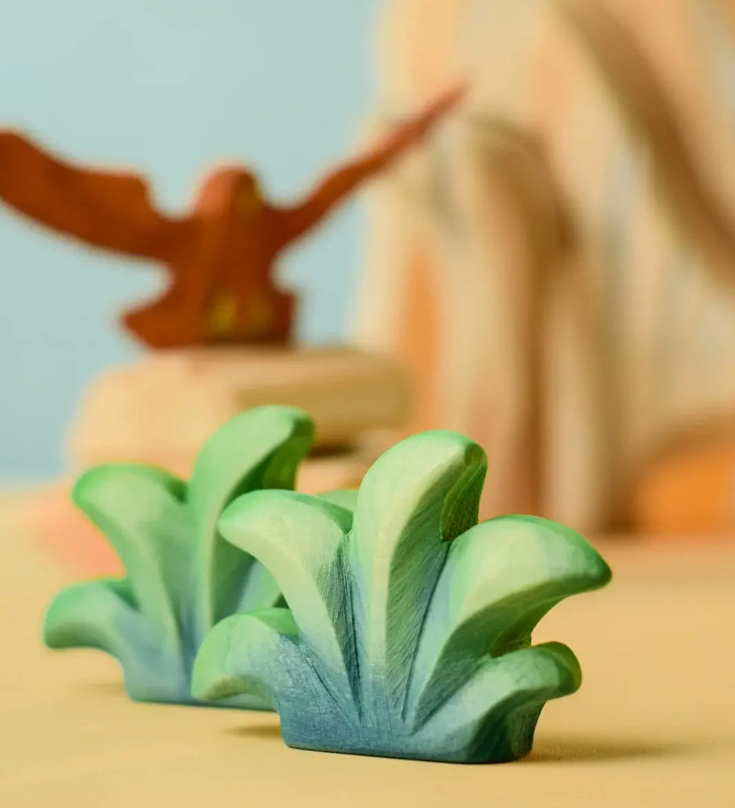 Bumbu mountain bush wooden toy figure placed at the front of small world play scene.