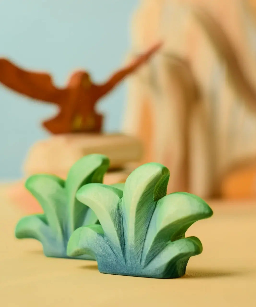 Bumbu mountain bush wooden toy figure placed at the front of small world play scene.