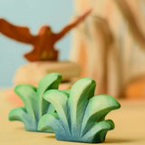 Bumbu mountain bush wooden toy figure placed at the front of small world play scene.