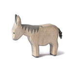 Side view of the Bumbu plastic free handmade toy donkey stood on a white background