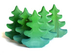 Group of plastic free solid wooden Bumbu fir trees in a line on a white background