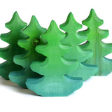 Group of plastic free solid wooden Bumbu fir trees in a line on a white background