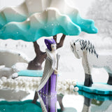 Bumbu wooden snow queen toy figure stood on a mirror next to a white horse figure and a Bumbu winter maple tree
