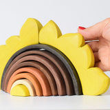 Hand holding the Bumbu eco-friendly handmade sunflower arch toy set on a white background