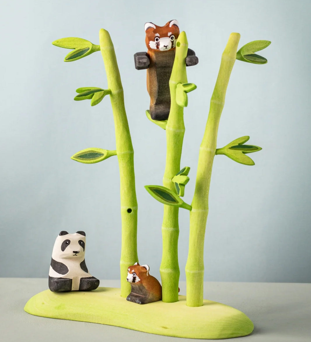 Bumbu wooden playful red panda figure in a nature play scene featuring Bumbu bamboo