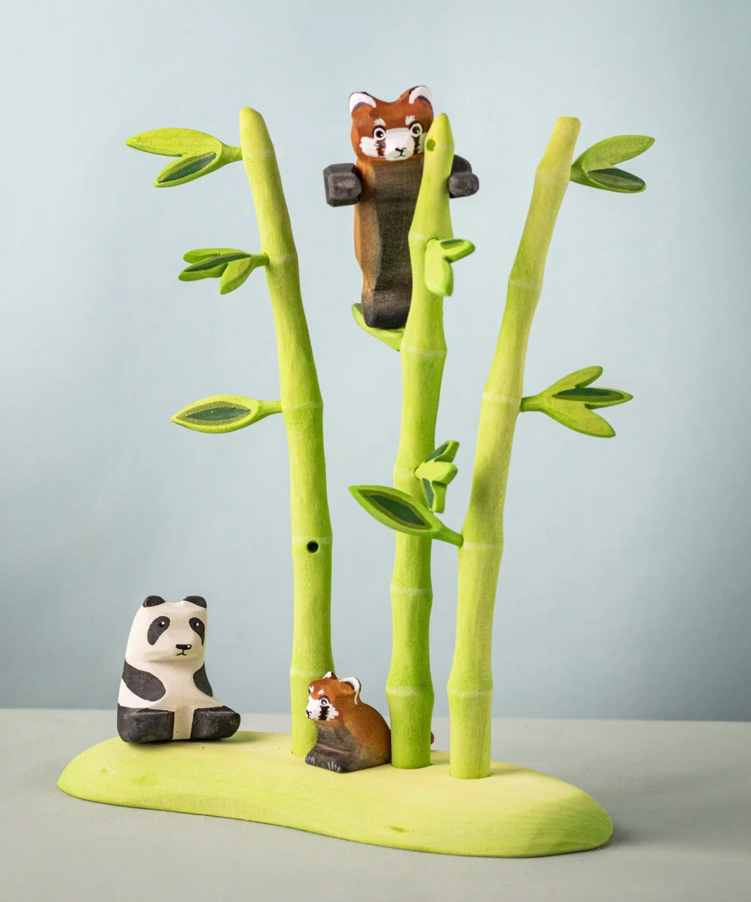 Bumbu wooden playful red panda figure in a nature play scene featuring Bumbu bamboo