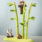 Bumbu wooden playful red panda figure in a nature play scene featuring Bumbu bamboo