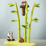 Bumbu wooden playful red panda figure in a nature play scene featuring Bumbu bamboo