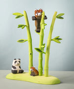 Bumbu wooden playful red panda figure in a nature play scene featuring Bumbu bamboo