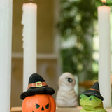 Bumbu pumpkin wizard and frog decorative figures placed on a natural wooden celebration ring. 