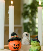 Bumbu pumpkin wizard and frog decorative figures placed on a natural wooden celebration ring. 