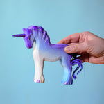 Adult holding a Bumbu Purple Unicorn
