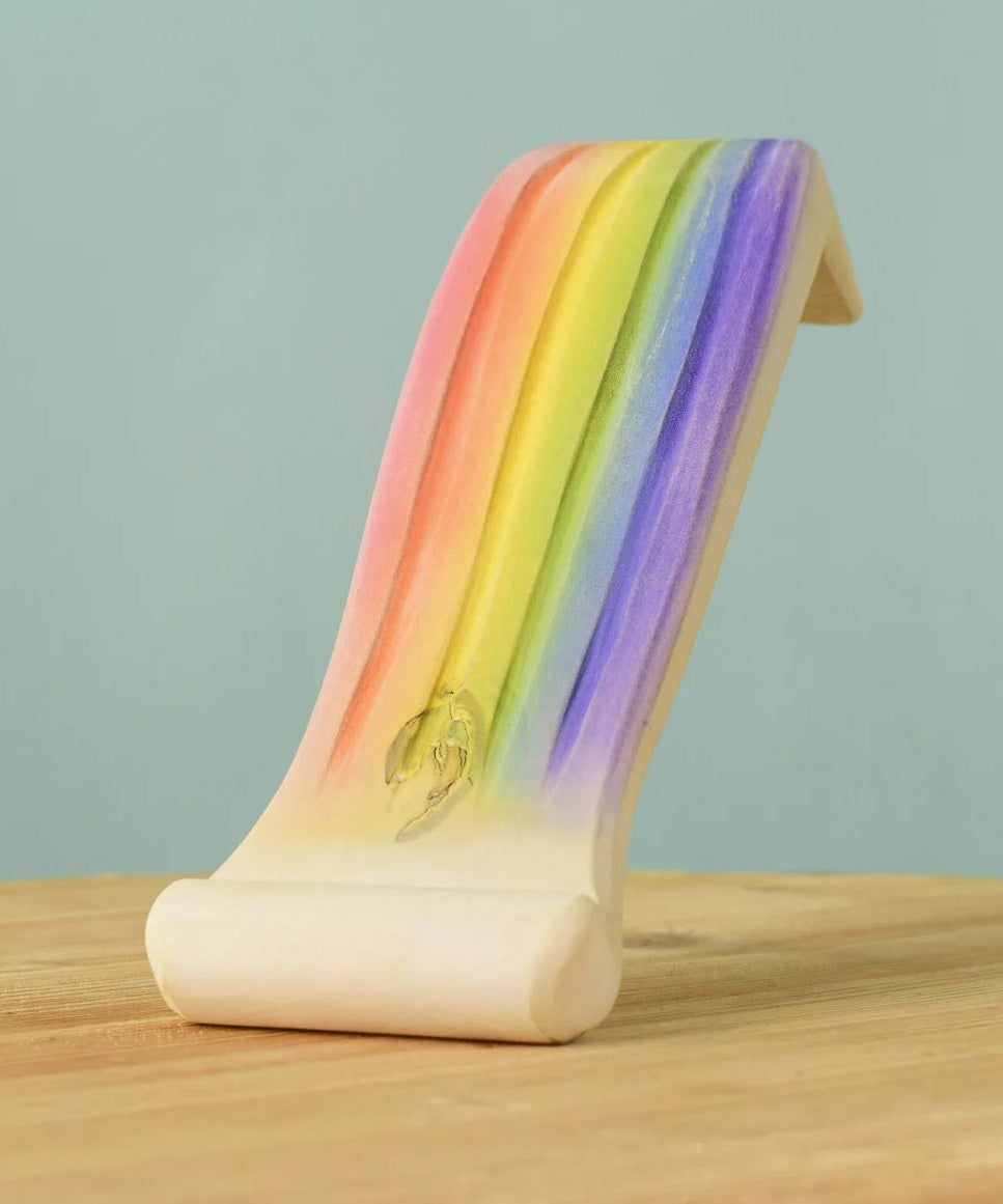 The Handmade Rainbow waterfall by Bumbu has been hand painted and is placed on a wooden surface.