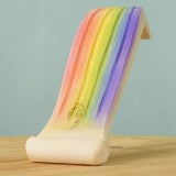 The Handmade Rainbow waterfall by Bumbu has been hand painted and is placed on a wooden surface.