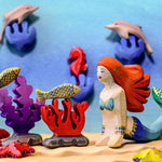 Bumbu wooden mermaid held in a hand