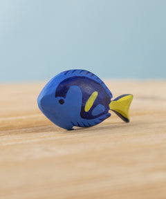 The Bumbu hand carved wooden Royal Blue Tang fish toy, hand painted in blue with yellow details. 