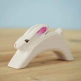 The Bumbu Toys Running Easter white Bunny on a wooden surface. 