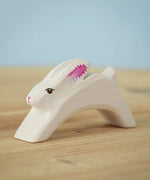 The Bumbu Toys Running Easter white Bunny on a wooden surface. 