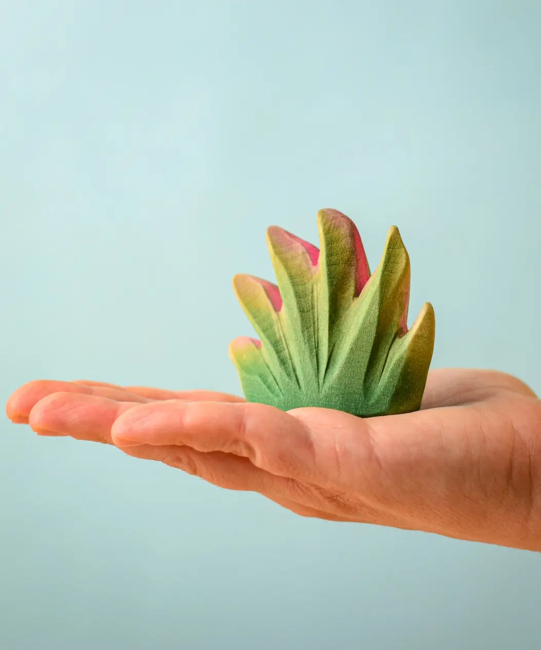 Bumbu Toys savanna bush wooden toy scenery figure placed on an adult's hand.