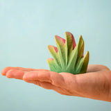 Bumbu Toys savanna bush wooden toy scenery figure placed on an adult's hand.
