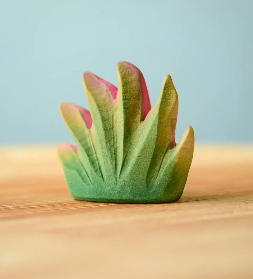 Bumbu Toys savanna bush wooden toy scenery figure placed on a wooden surface. 