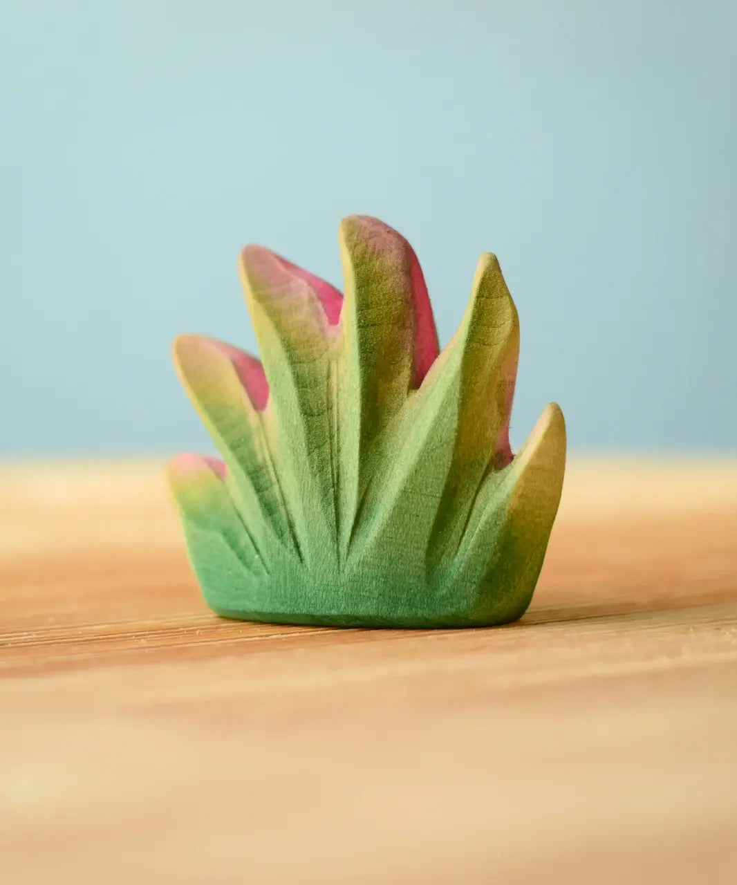 Bumbu Toys savanna bush wooden toy scenery figure placed on a wooden surface. 