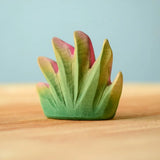 Bumbu Toys savanna bush wooden toy scenery figure placed on a wooden surface. 