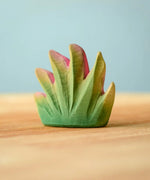 Bumbu Toys savanna bush wooden toy scenery figure placed on a wooden surface. 