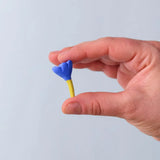 Bumbu blue small wooden flower wooden toy scenery in an adult's hand.