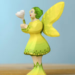 A Bumbu Small Wooden Flower in white shown placed in the woodland fairy's hands