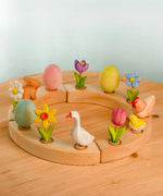 Wooden celebration ring with Bumbu spring festive decoration figures standing inside