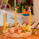 A Spring display showing all Bumbu festive decorative figures, celebration ring and candles standing on a table 