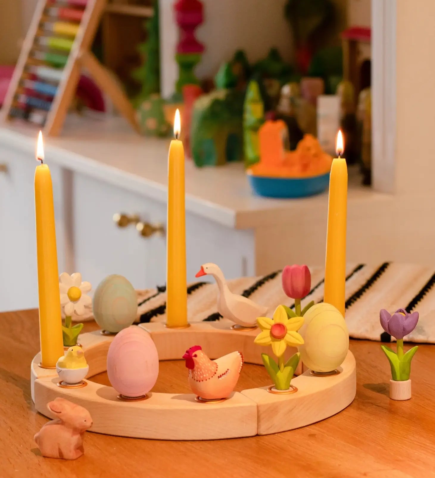 A Spring display showing all Bumbu festive decorative figures, celebration ring and candles standing on a table 