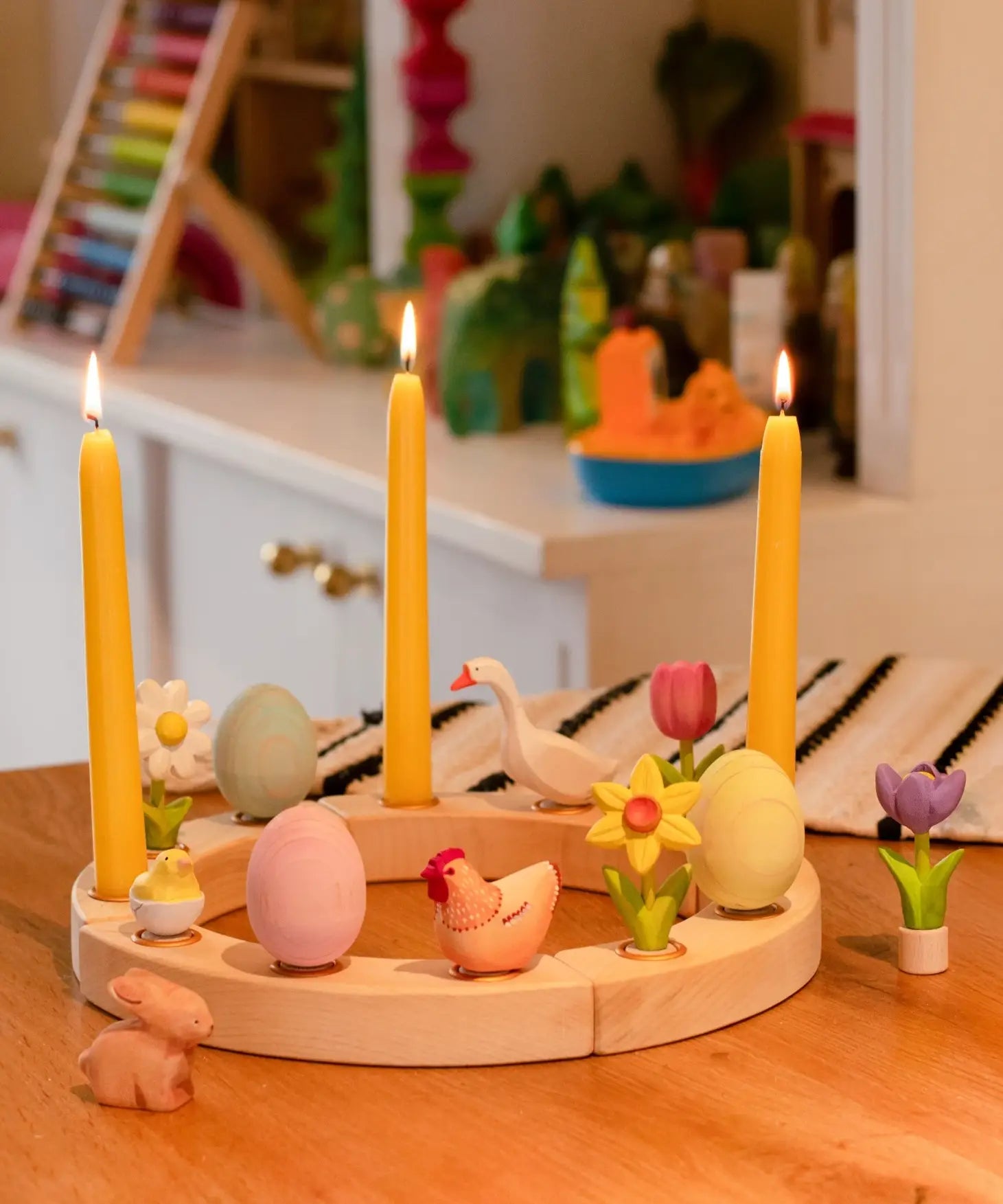 A Spring display showing all Bumbu festive decorative figures, celebration ring and candles standing on a table 
