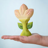 The Bumbu Toys Zia Spring Flower shown in an adult's hand.