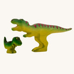 Bumbu Baby and large Wooden T-Rex Dinosaurs on a plain background.