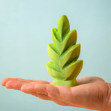 Bumbu Toys thuja shrub wooden toy scenery piece placed on an adult's hand.