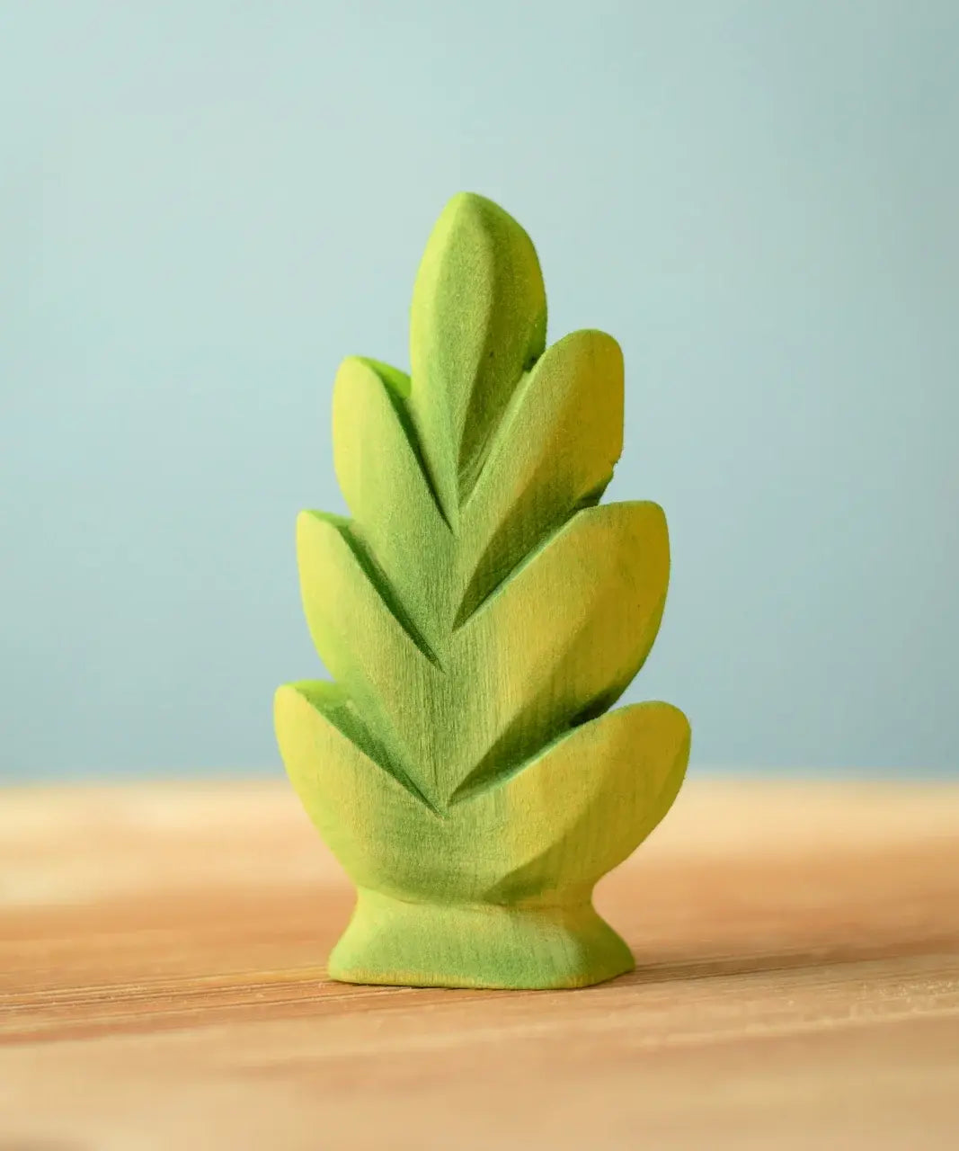 Bumbu Toys thuja shrub wooden toy scenery piece placed on a wooden surface.