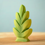Bumbu Toys thuja shrub wooden toy scenery piece placed on a wooden surface.