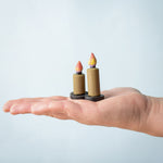 Bumbu Toys wooden Candle figures Set pictured on the palm of an adult's hand.