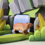 Bumbu Toys Wooden Capybara in a scene with Bumbu rocks and grass.