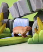 Bumbu Toys Wooden Capybara in a scene with Bumbu rocks and grass.