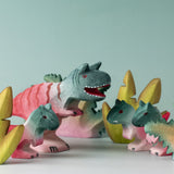 A small world play scene with wooden toys from Bumbu including the Bumbu Toys Big and small  Carnotaurus dinosaurs. 