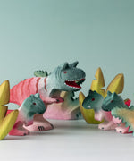 A small world play scene with wooden toys from Bumbu including the Bumbu Toys Big and small  Carnotaurus dinosaurs. 