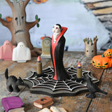 Bumbu Toys Dracula The Vampire Wooden Halloween Figure placed on a wooden cobweb in the middle of a small world play scene with Bumbu Halloween and Autumn themed toys.
These expertly hand crafted items are part of a large range of wooden toys available here at Babipur.  

