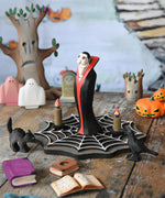 Bumbu Toys Dracula The Vampire Wooden Halloween Figure placed on a wooden cobweb in the middle of a small world play scene with Bumbu Halloween and Autumn themed toys.
These expertly hand crafted items are part of a large range of wooden toys available here at Babipur.  
