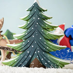 A large Bumbu Snowy Fir Tree placed in the centre of a festive small world play scene. 