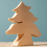 A Bumbu large paint your own wooden toy figure placed on a wooden surface. This paint your own figure is part of a large collection of paint your own wooden figures available at Babipur.