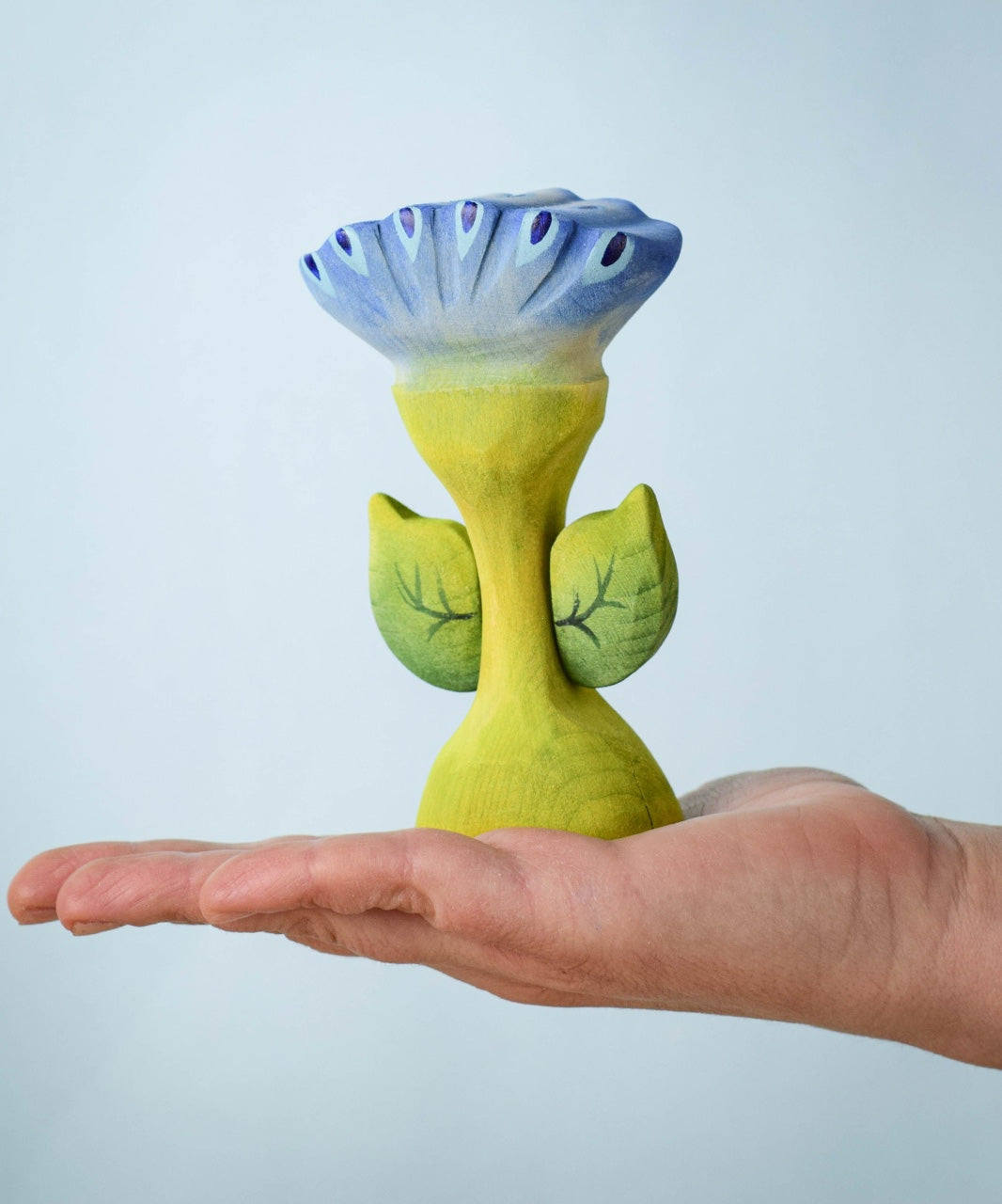 The Bumbu Toys Flama Spring Flower shown in an adult's hand. 