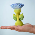 The Bumbu Toys Flama Spring Flower shown in an adult's hand. 
